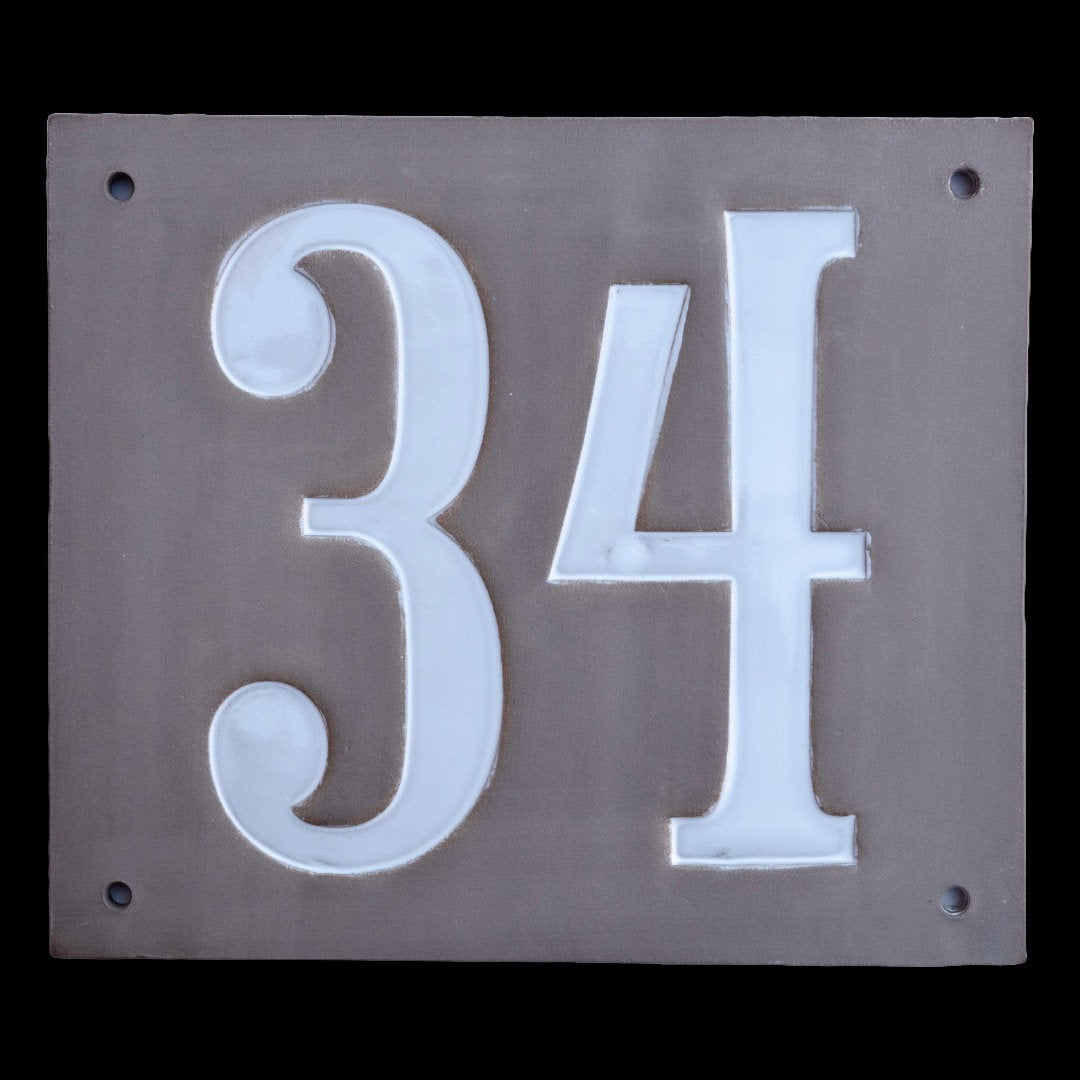 Rechteckiges graues Keramik-Hausschild mit erhabenen weißen Ziffern 34
