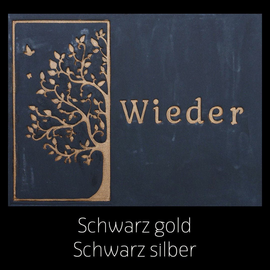 Schwarzes Keramikschild mit goldener Baumgravur und dem Schriftzug 'Wieder'